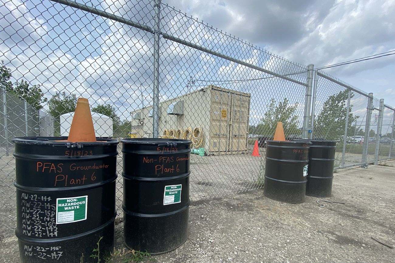 barrels in front of fence