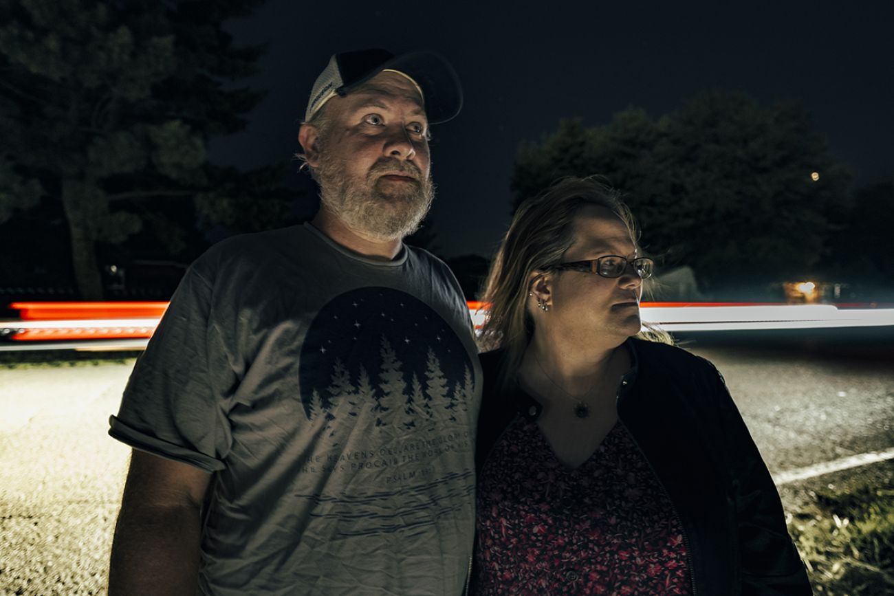 two people standing outside at night