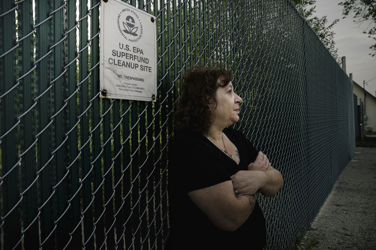 Carol Garza leans against the fence