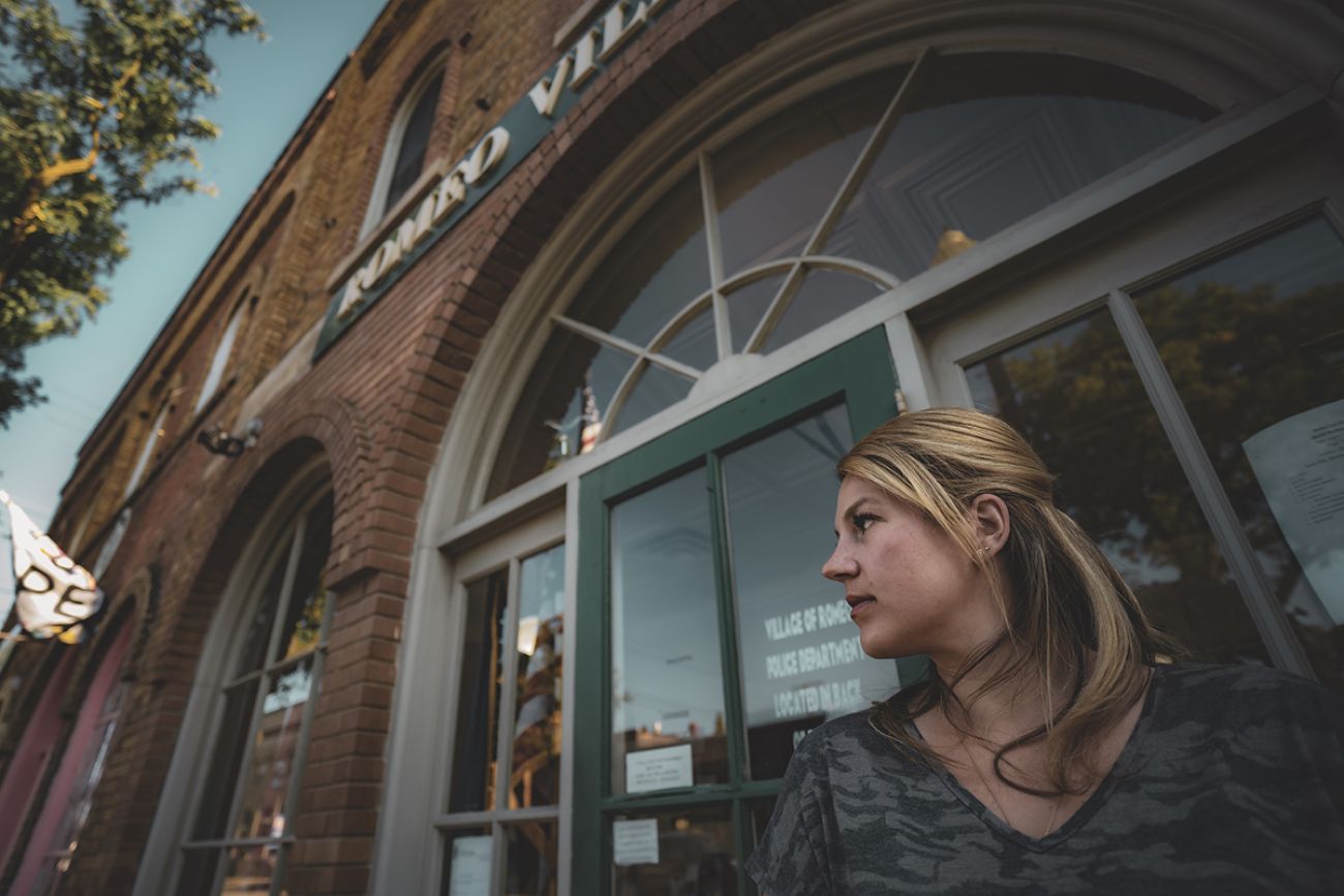 Village President Meagan Poznanski in front of the Romeo hall
