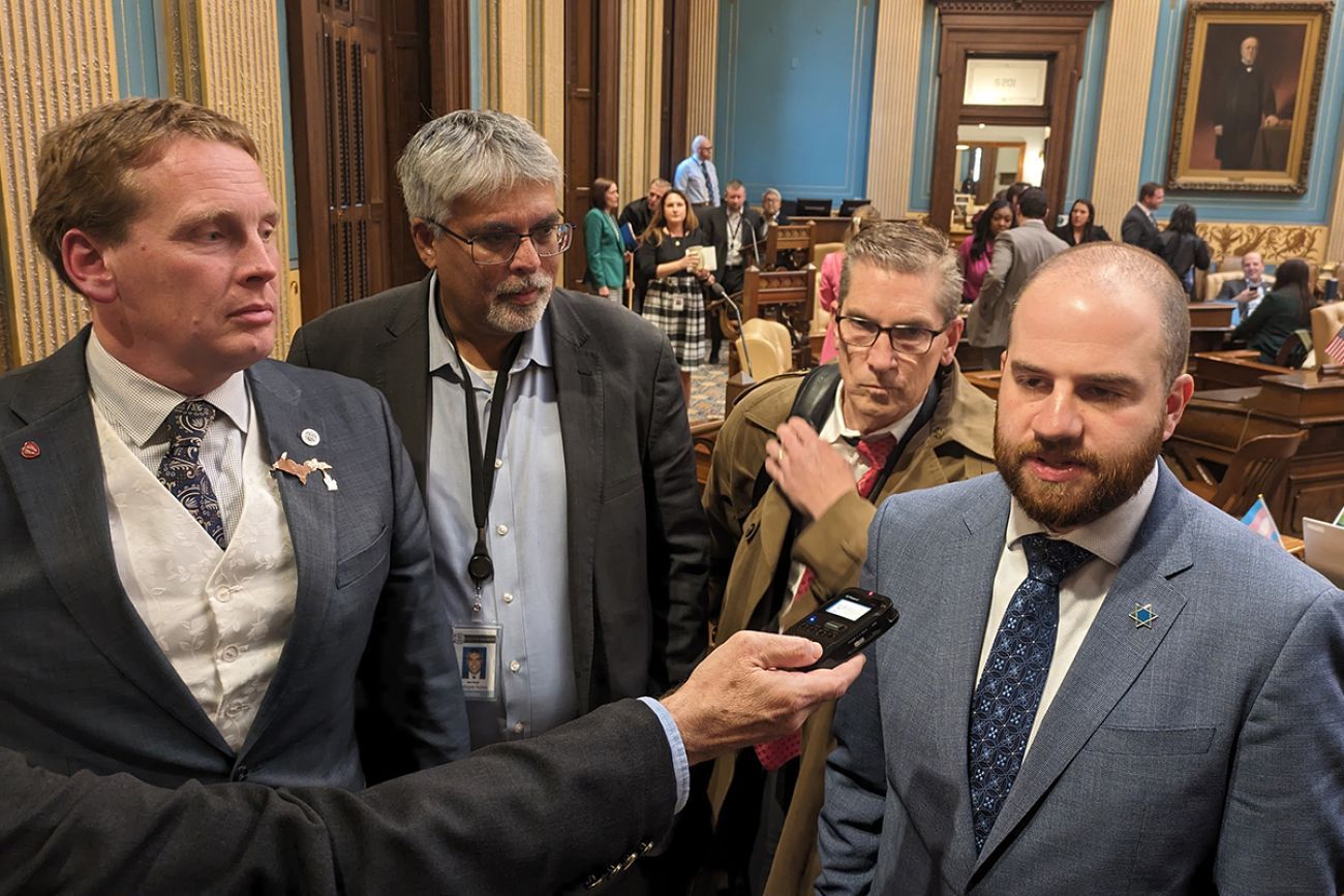 group of lawmakers talking into a microphone