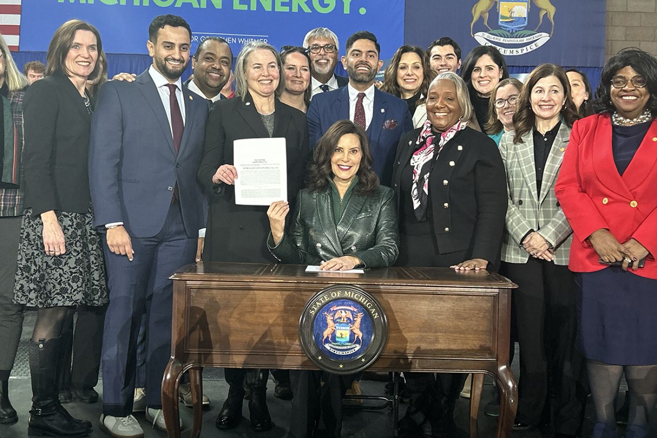 Gov. Gretchen Whitmer surrounded by lawmakers