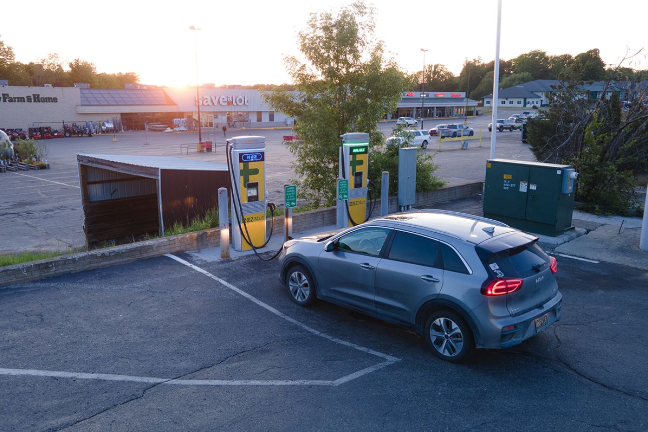 Electric car charging at a ChargePoint DC fast charger at sunset