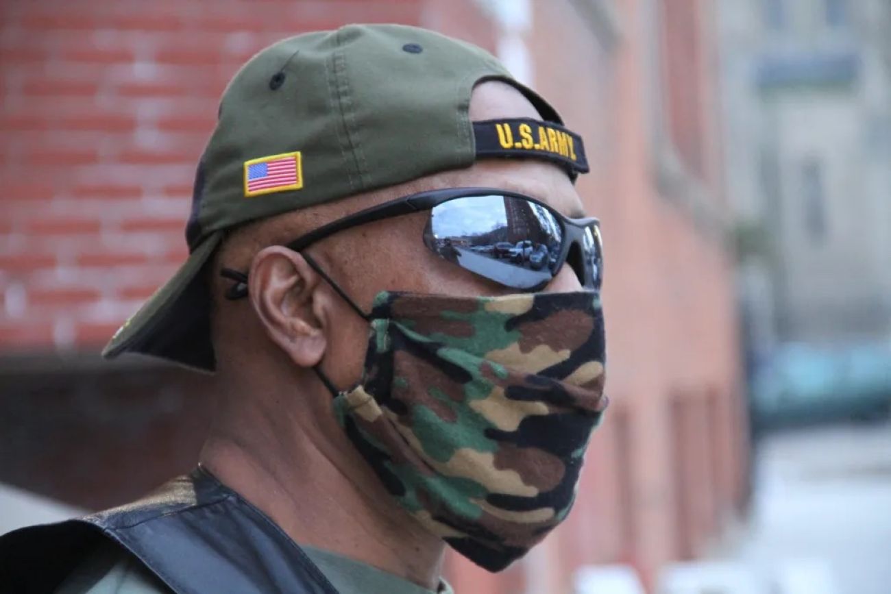 Al Brantley wearing an army hat and face mask 
