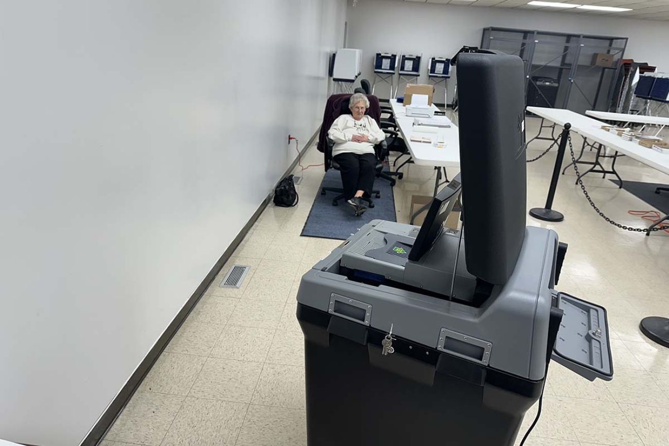 Poll worker Candi Mishler sitting in a chair