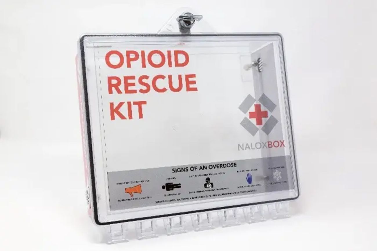 Naloxbox, a plastic container for Narcan. the box also has information about signs of an overdose