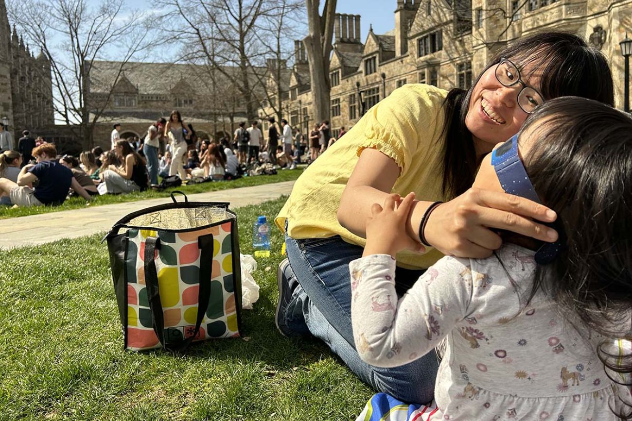 woman putting glasses on daughter