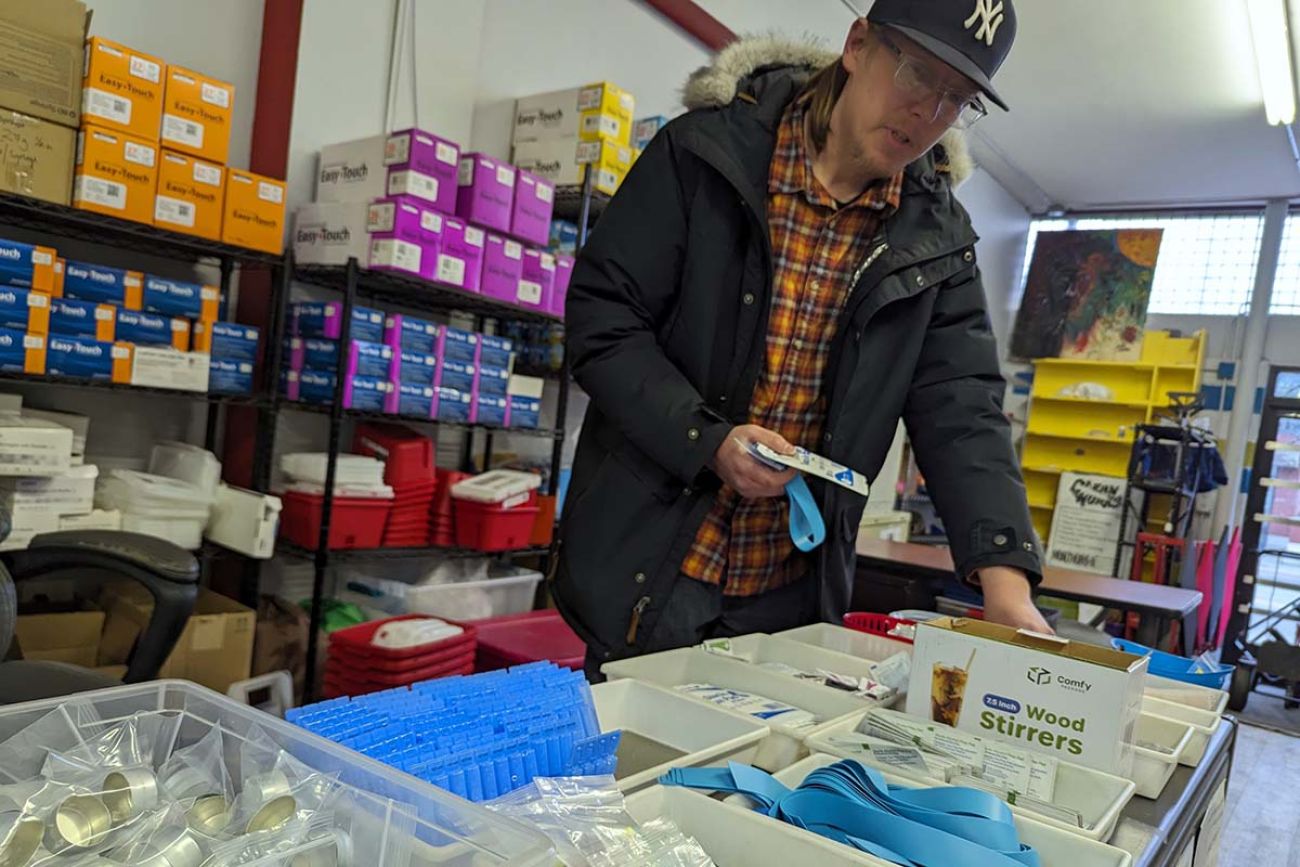 Steve Alsum looking at supplies on a table