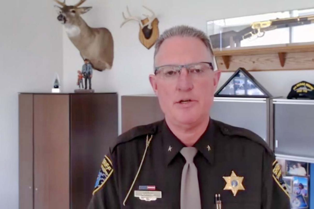  Livingston County Sheriff Mike Murphy looking at the camera in his office. He is in his brown officer uniform 