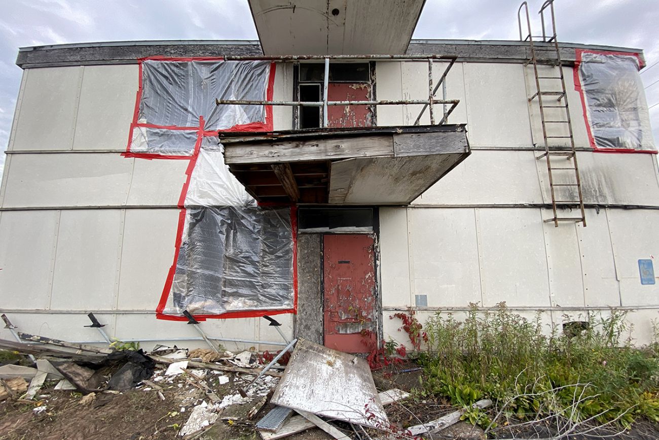 A blighted building. There's plastic covering what once windows
