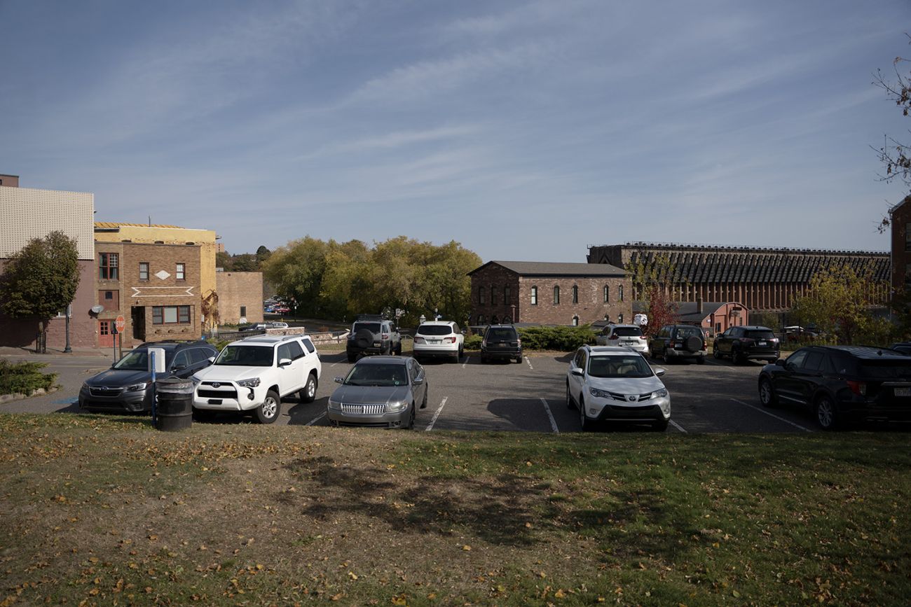 A green space in front of a parking lot
