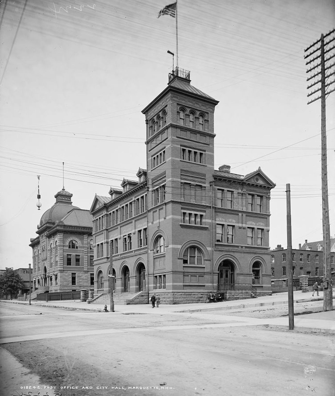 Black and white photo: United States Post Office building on West Washington Street and North Third Street in downtown Marquette