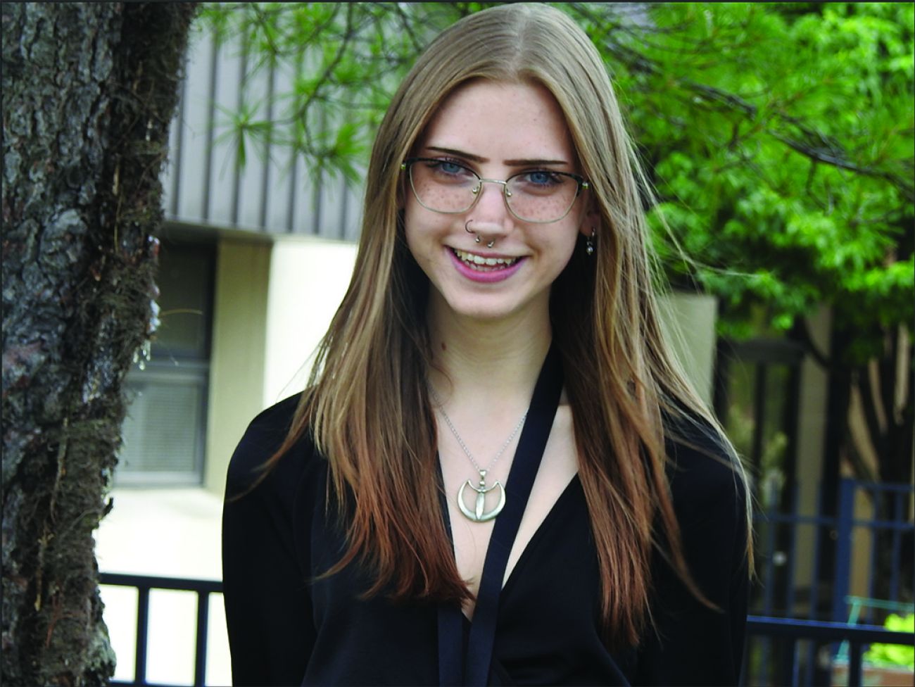 Helena Cole, wearing black, poses for a picture outside