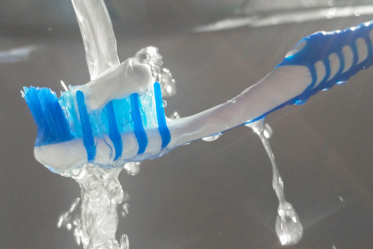 blue toothbrush and fluoride toothpaste