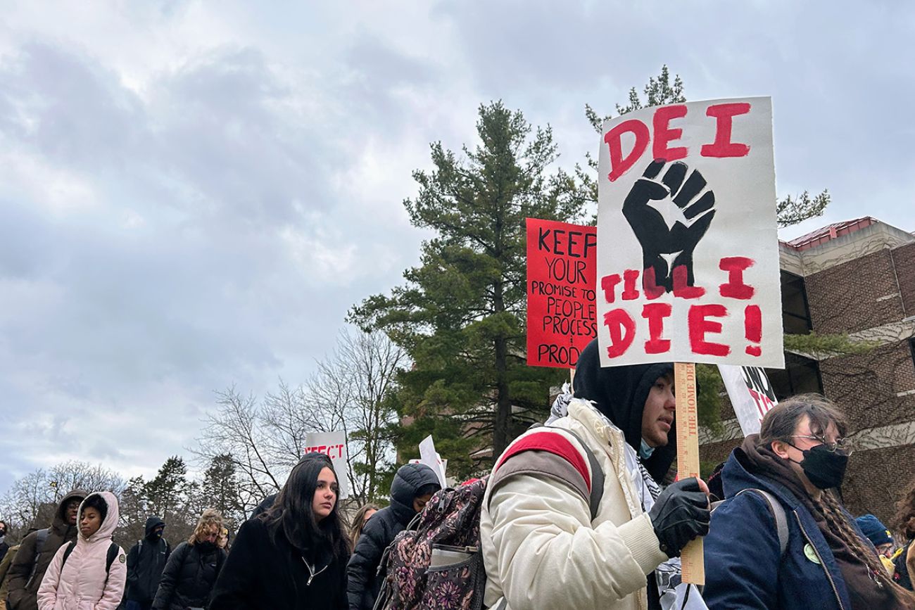 Someone holding a sign that says "DEI till I die"