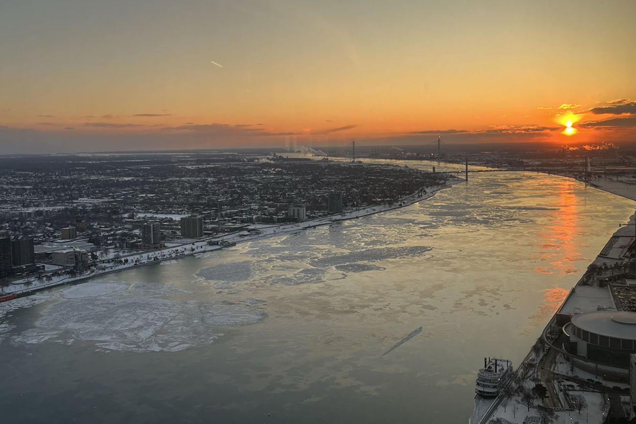 An aerial view of the Detroit River at sunset