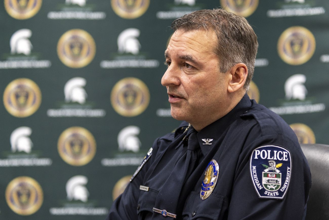 MSU's Mike Yankowski sits down in his police uniform. 