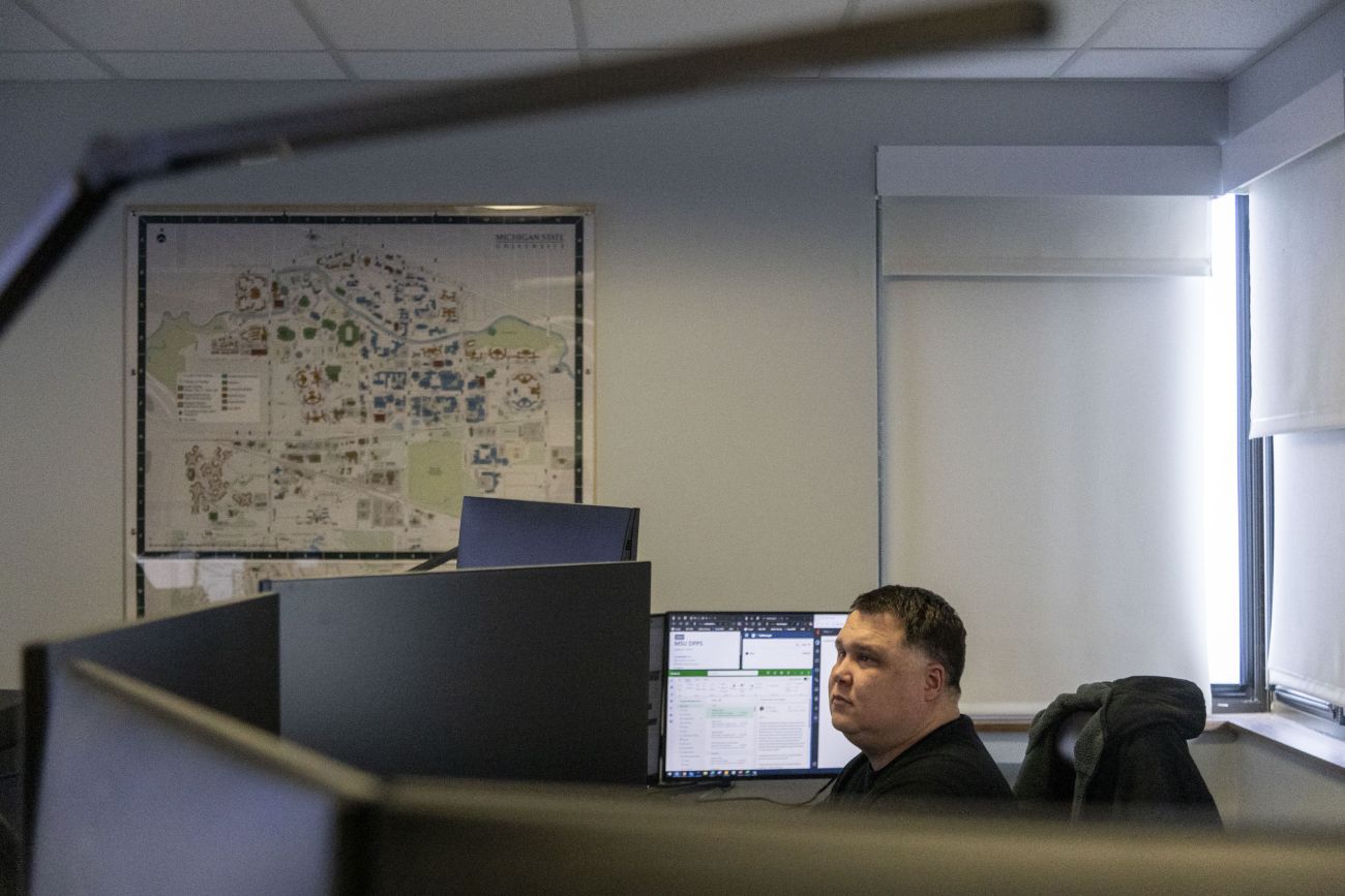 A man looking at computers. 