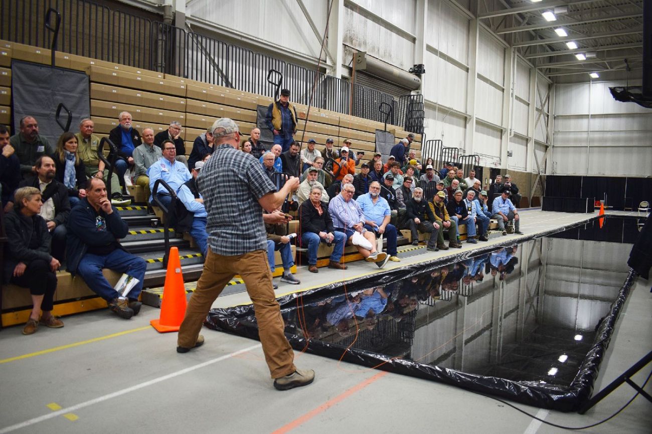 Speaker addresses crowd at fly fishing expo