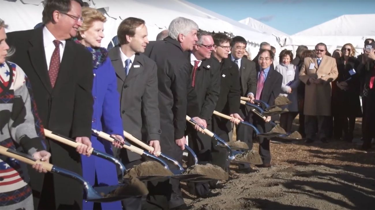 Federal, state and local officials solving dirt.