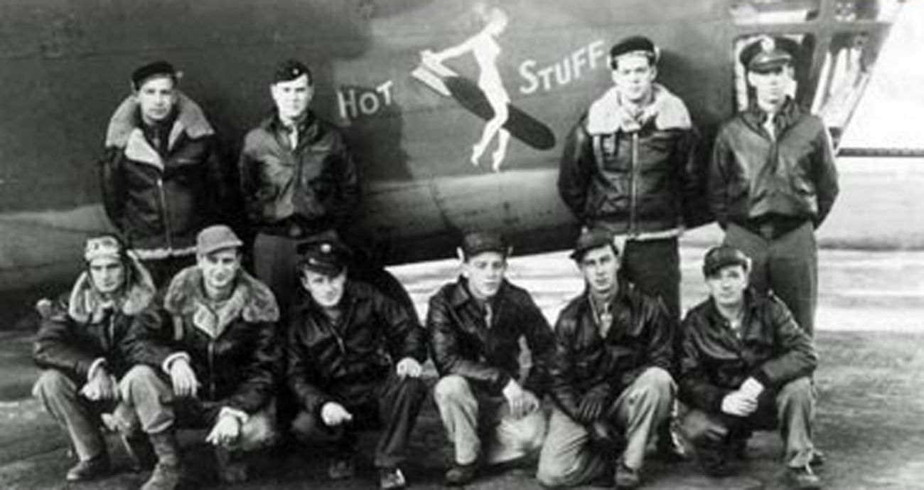 A historic photo of B-24 crew in front of a plane