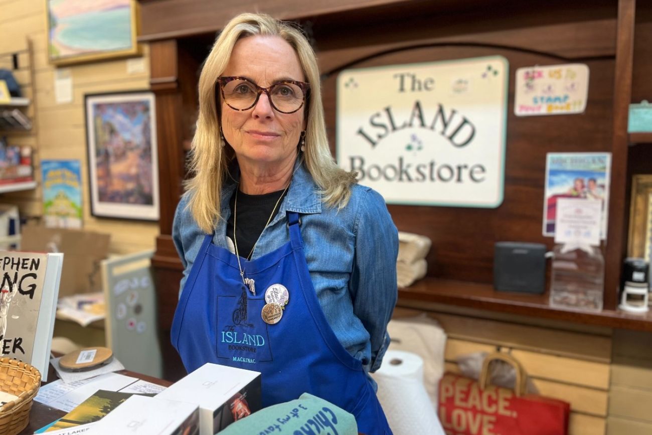A woman stands at the counter of a shop on Mackinac Island