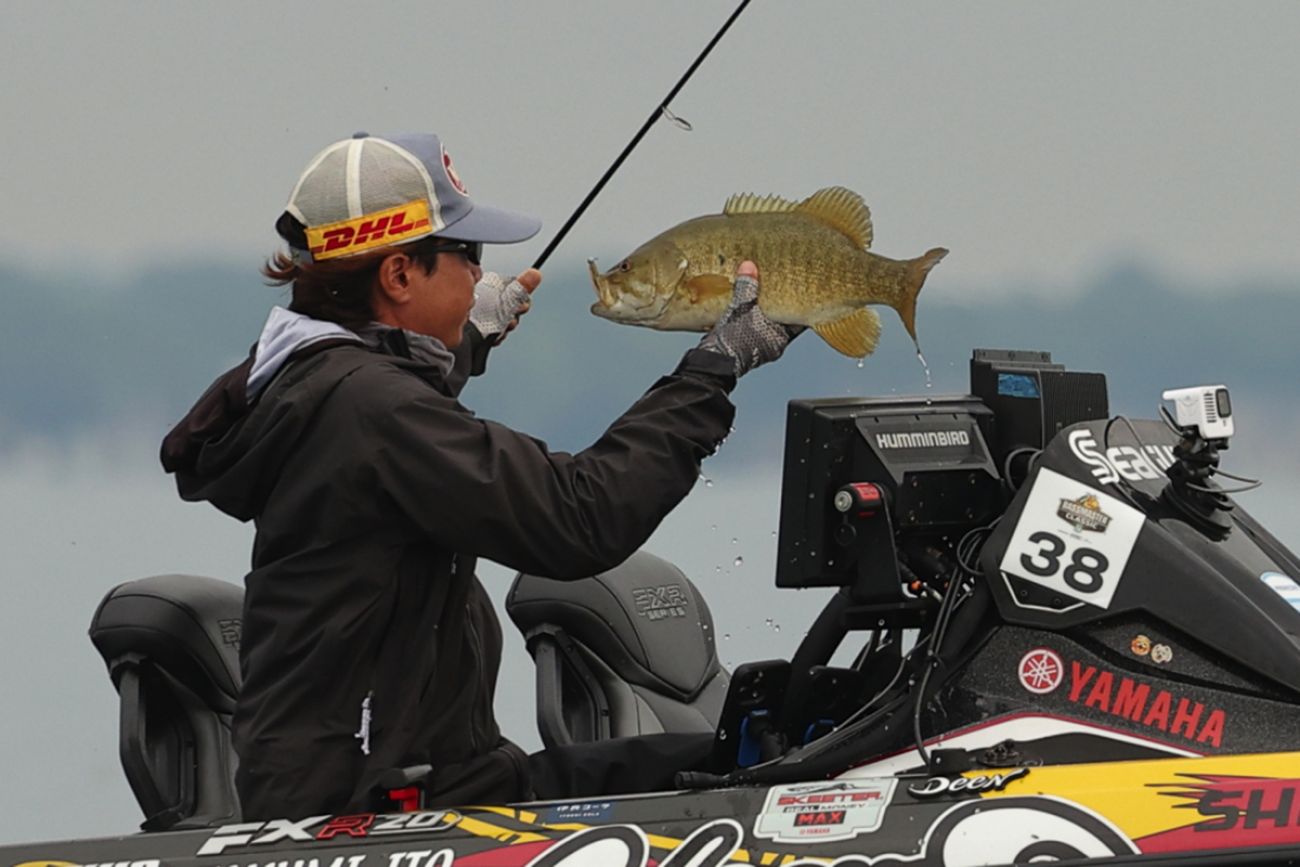 An angler holds up a fish.