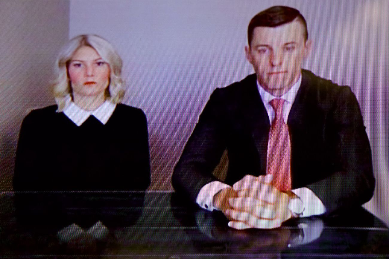 Stephanie Chatfield sits to the left of Lee Chatfield at a desk