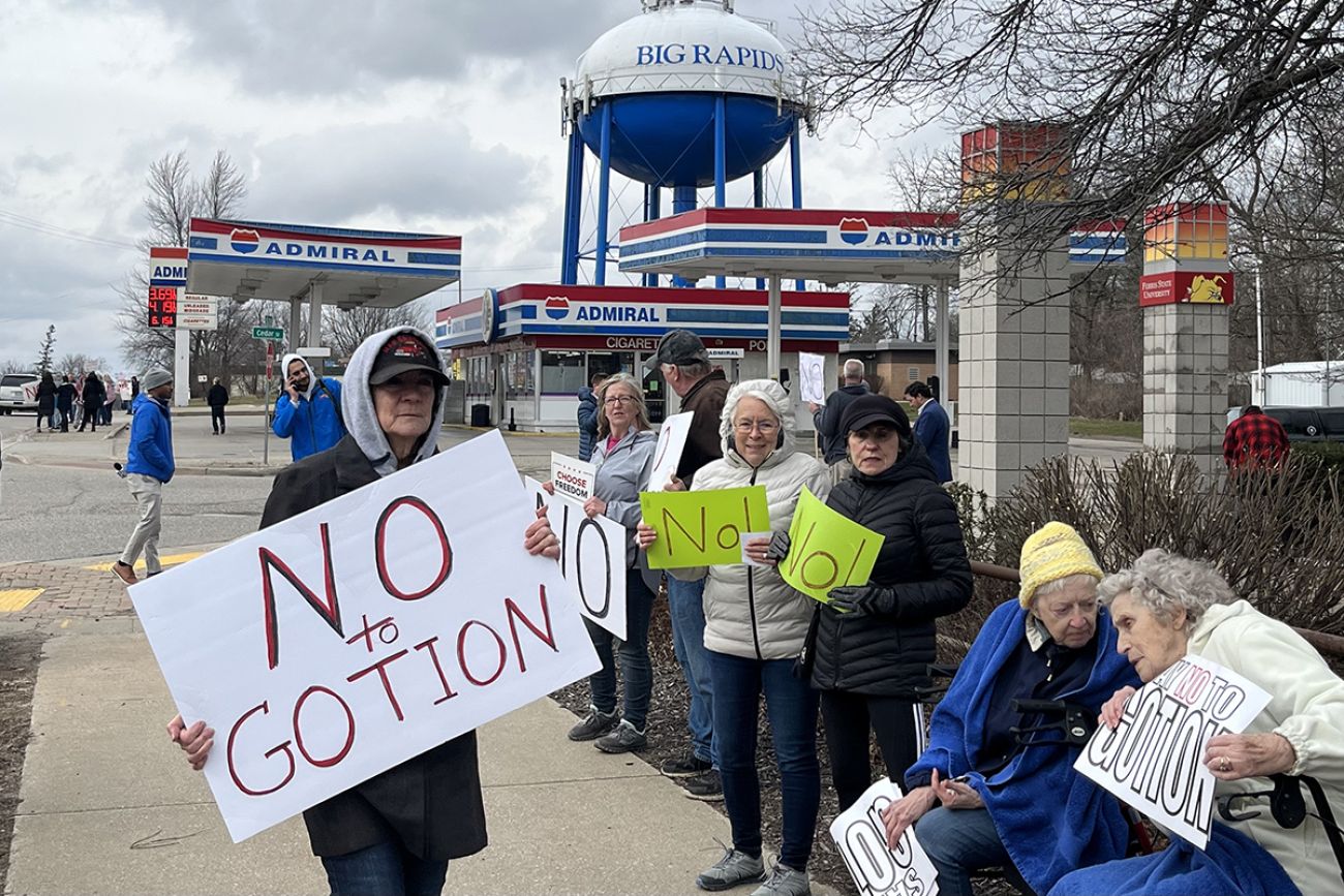 Marianne Pitts, center in white jacket, joined several hundred people in Big Rapids in 2023, lining both sides of South State Street to protest Gotion.