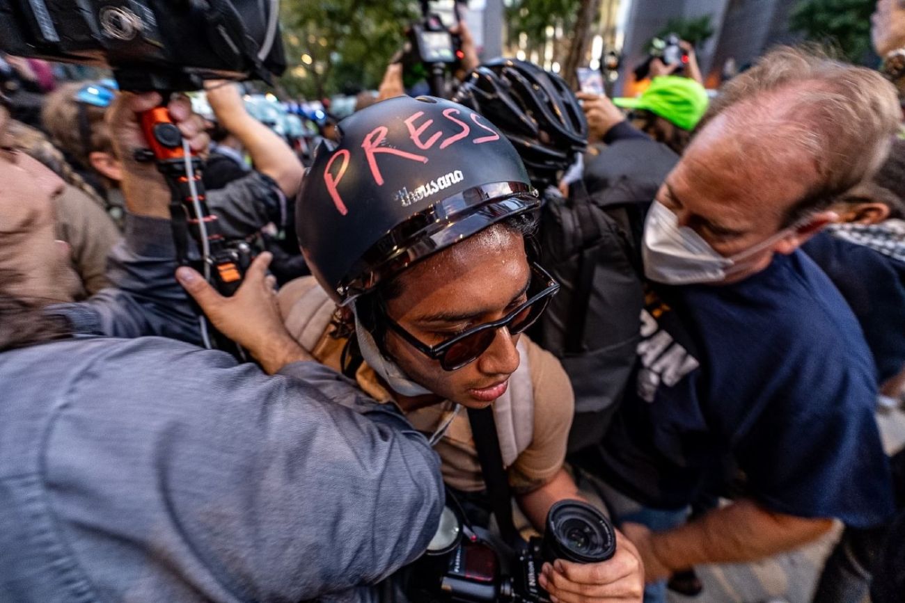 Student journalist moves through crowd