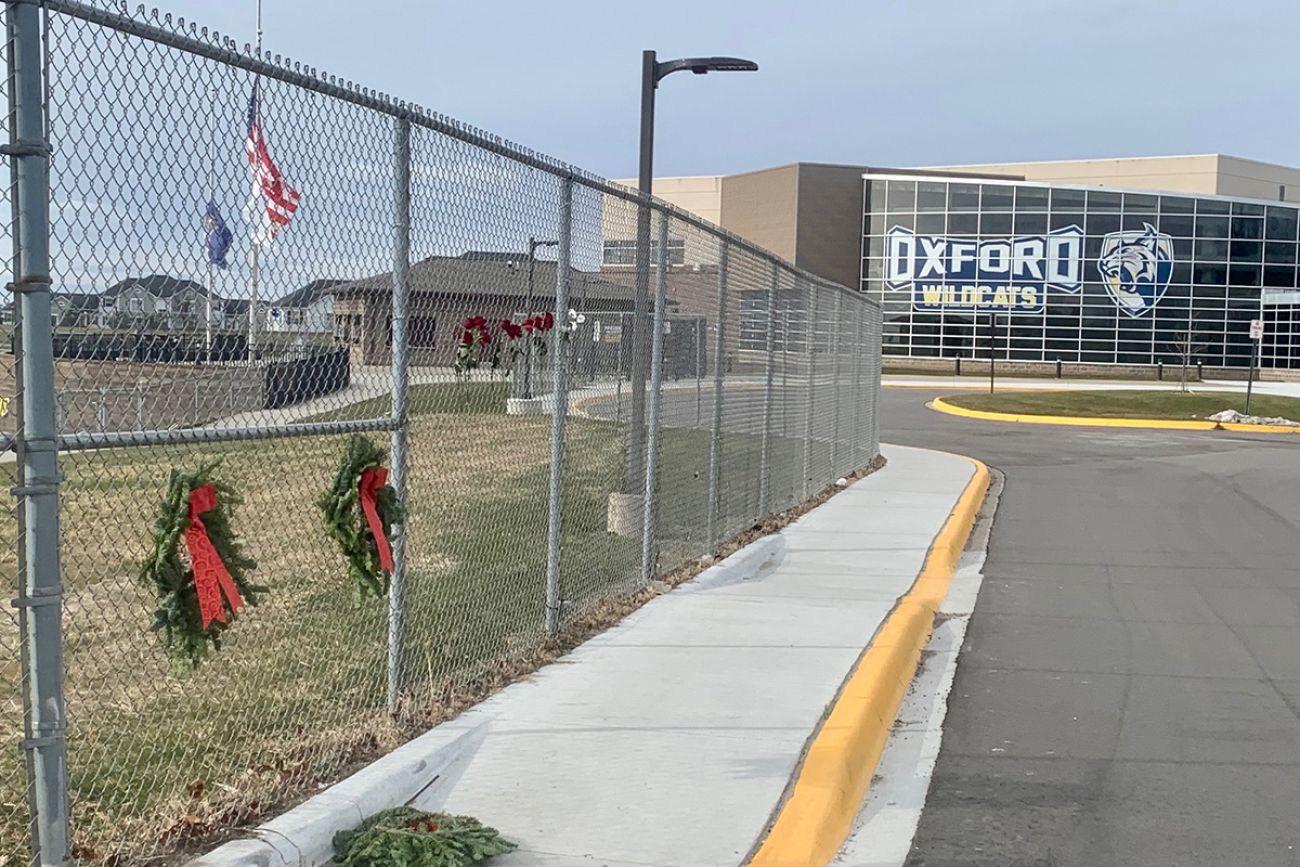 Outside view of Oxford High School. A memorial is on the side.