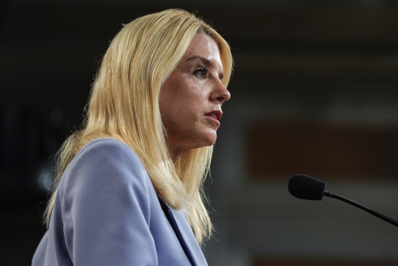 US Attorney General Pam Bondi speaks into a microphone.