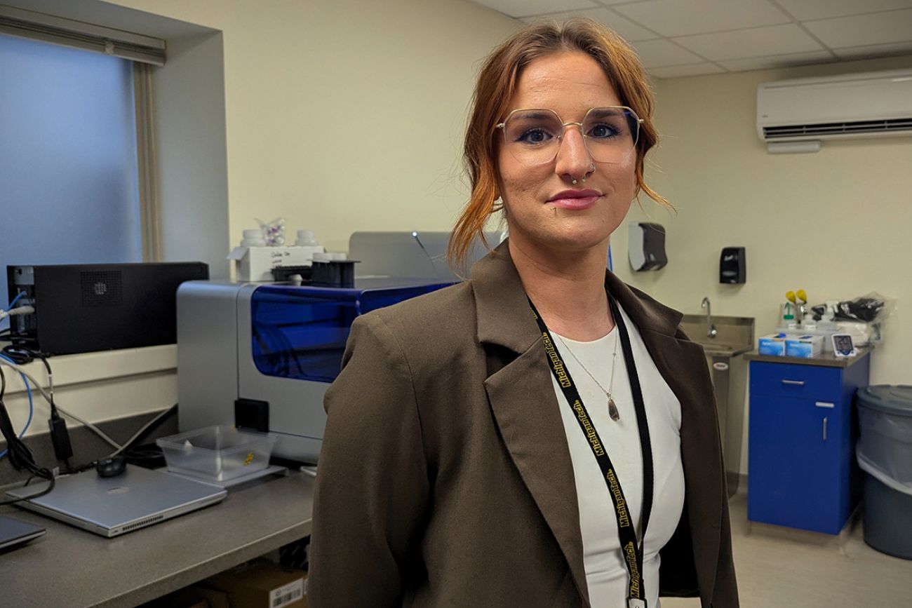 Penny Nowlin stands in a lab.