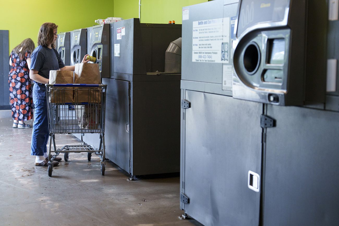Woman at the recycling center at a grocery store in Ann Arbor, Michigan.
