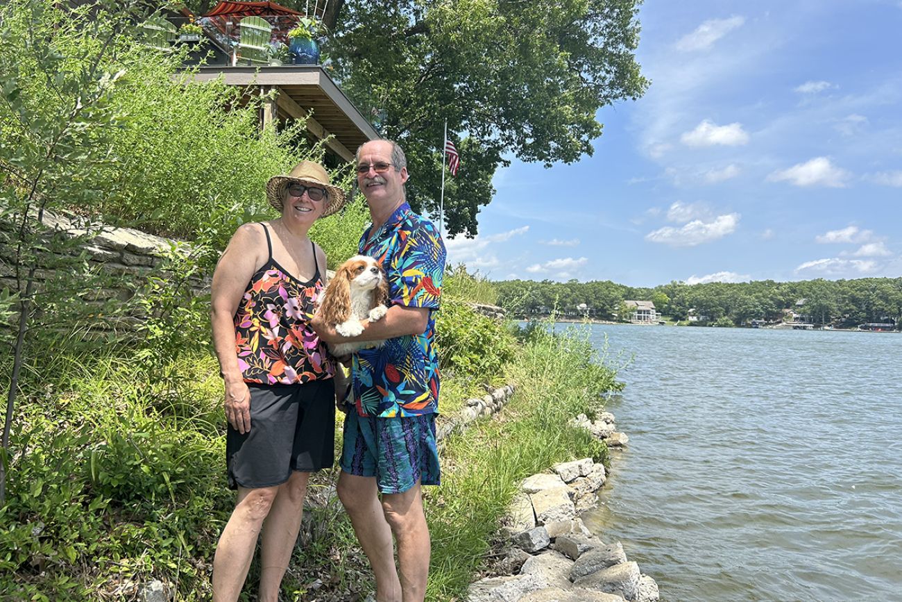 Sarah Cain and Brian Bradcoski holds a small dog near Brooks Lake in Newaygo, Michigan.