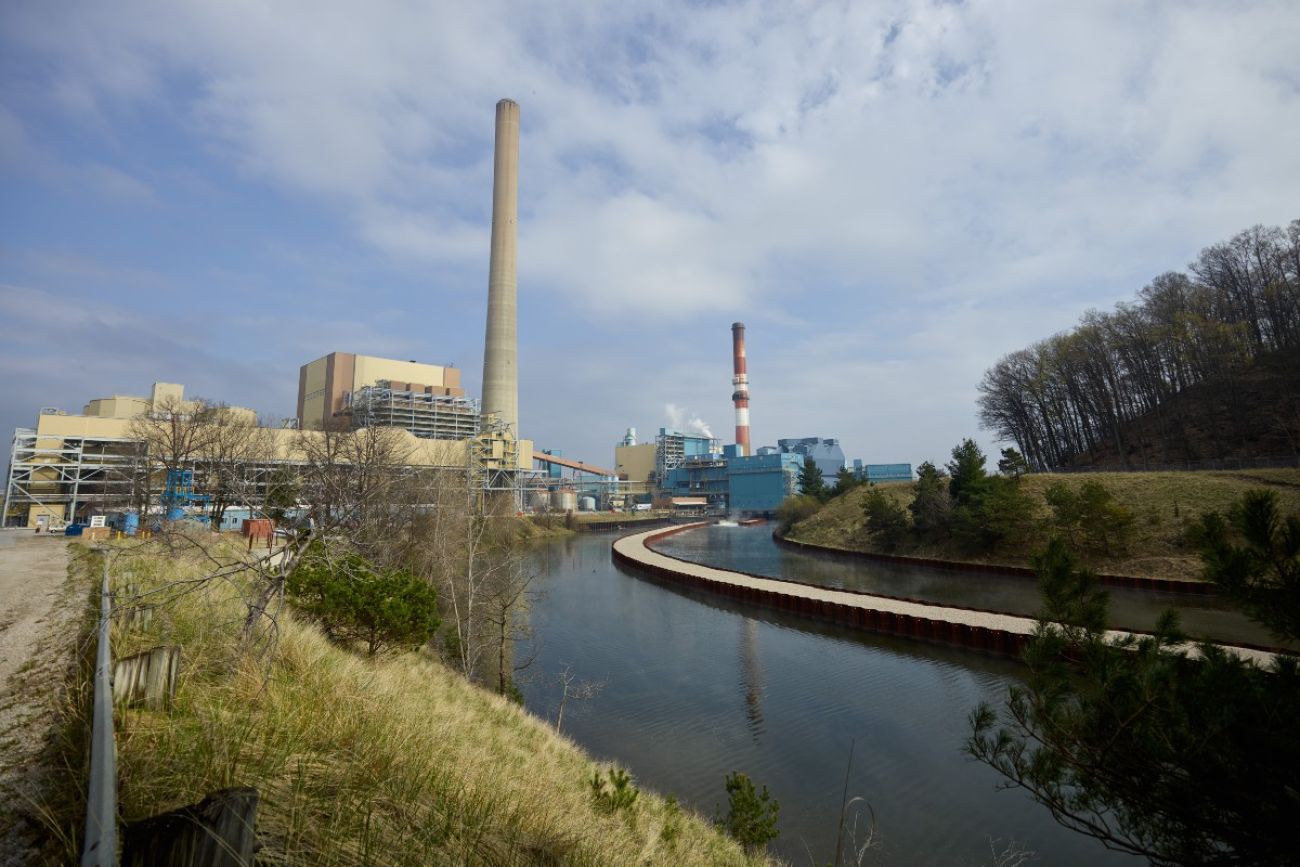 A power plant is seen alongside a river