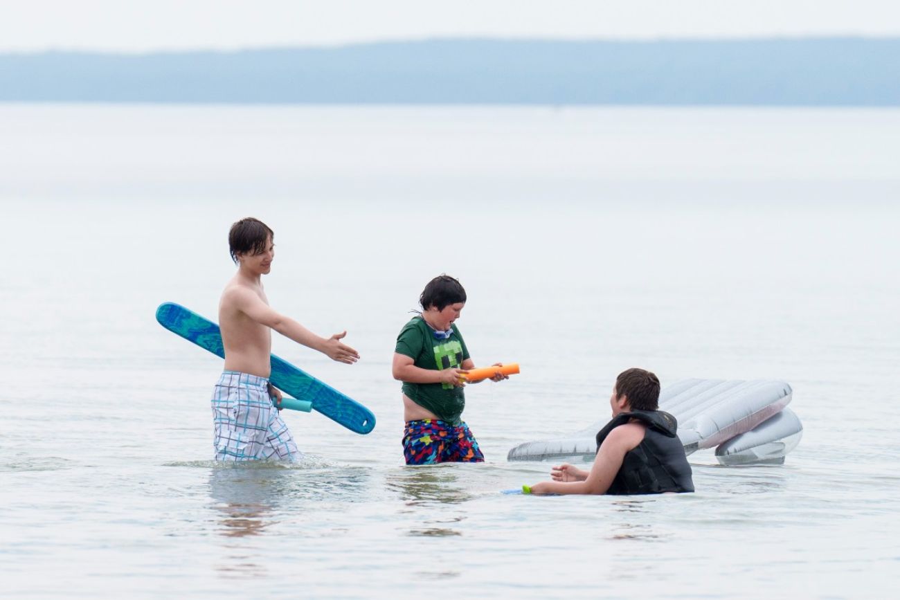 Kids swim in a lake