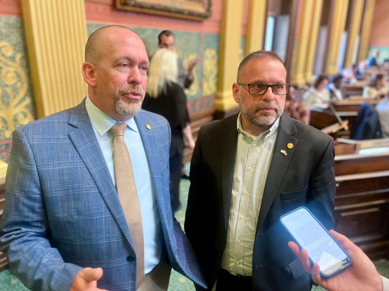 Rep. Mike Harris, R-Waterford Township, and Rep. Mike McFall, D-Hazel Park, speak to a reporter.