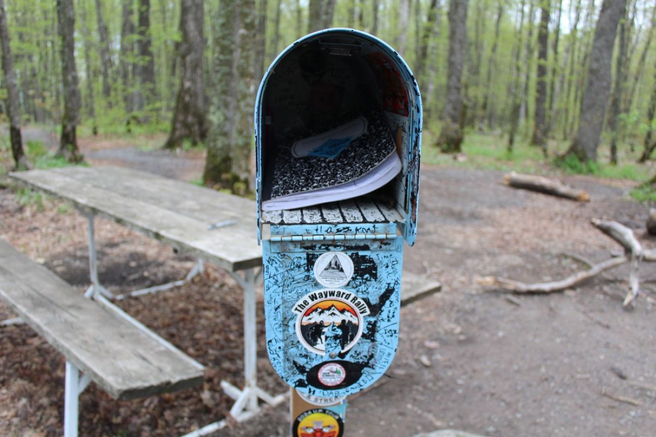 A mailbox is open, revealing a notebook inside