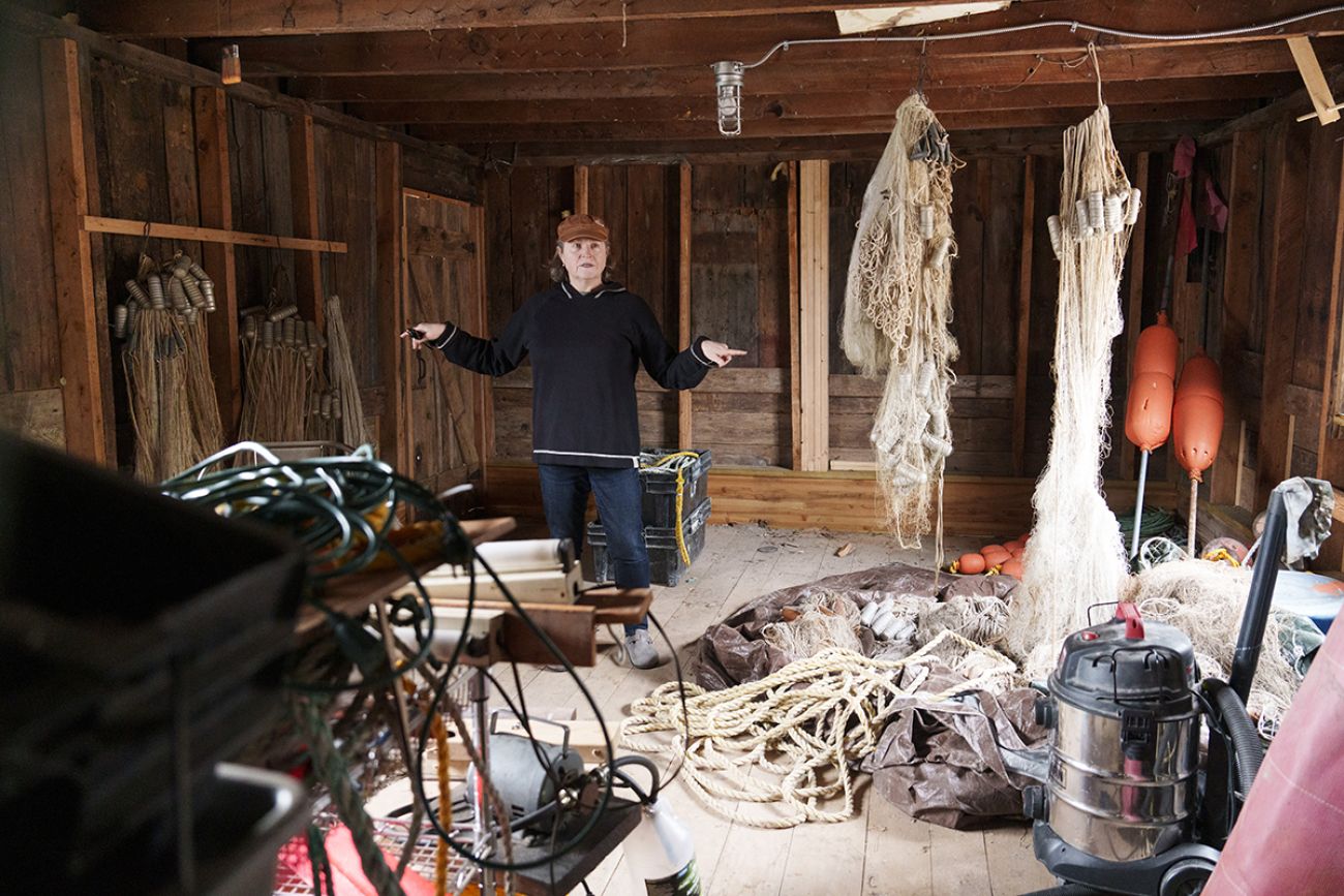 Amanda Holmes in a wooden fish shanty.