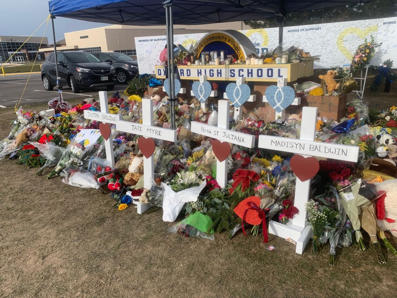 Names of students killed in Oxford High School shooting are displayed on white crosses amid a memorial