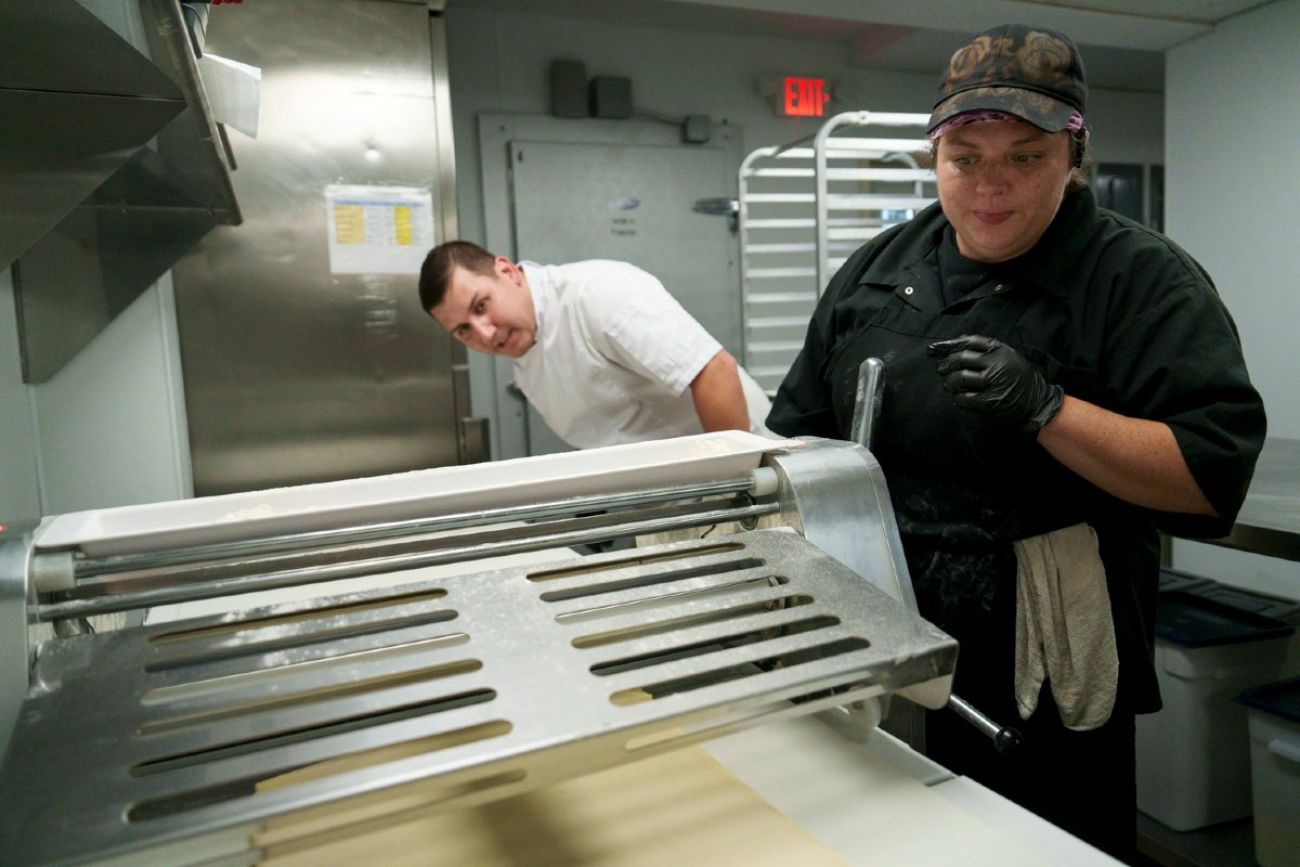 Two people prepare pastry dough