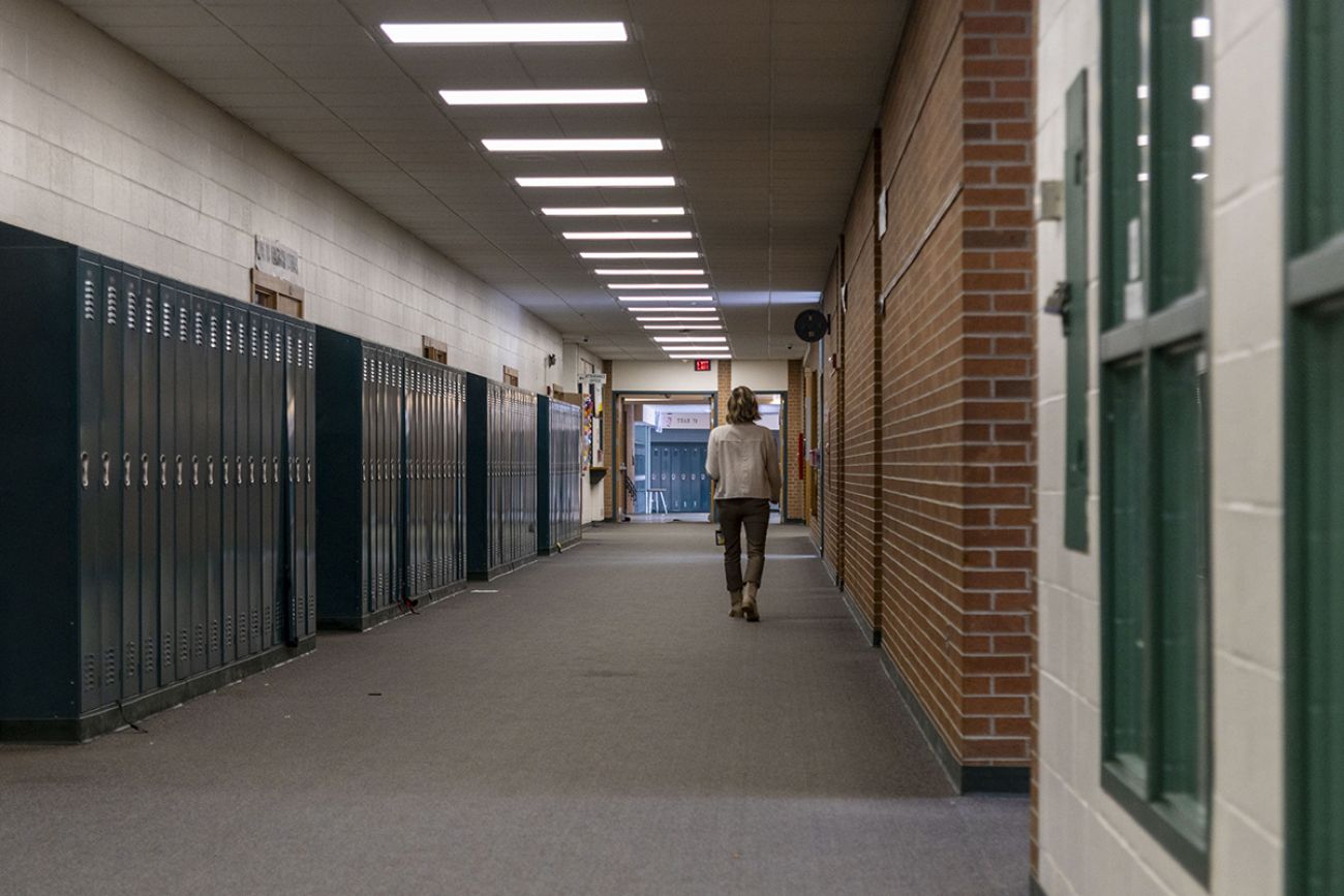 A teacher walks in a hallway at a Michigan school in the Holt Public School District on Tuesday, Jan. 28, 2025.