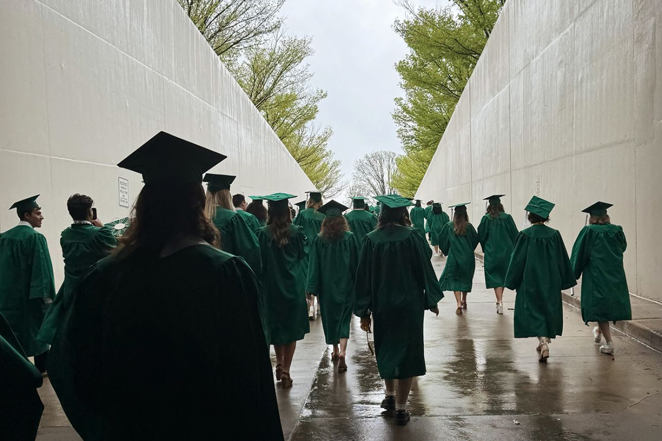 People walking in their cap and gowns.