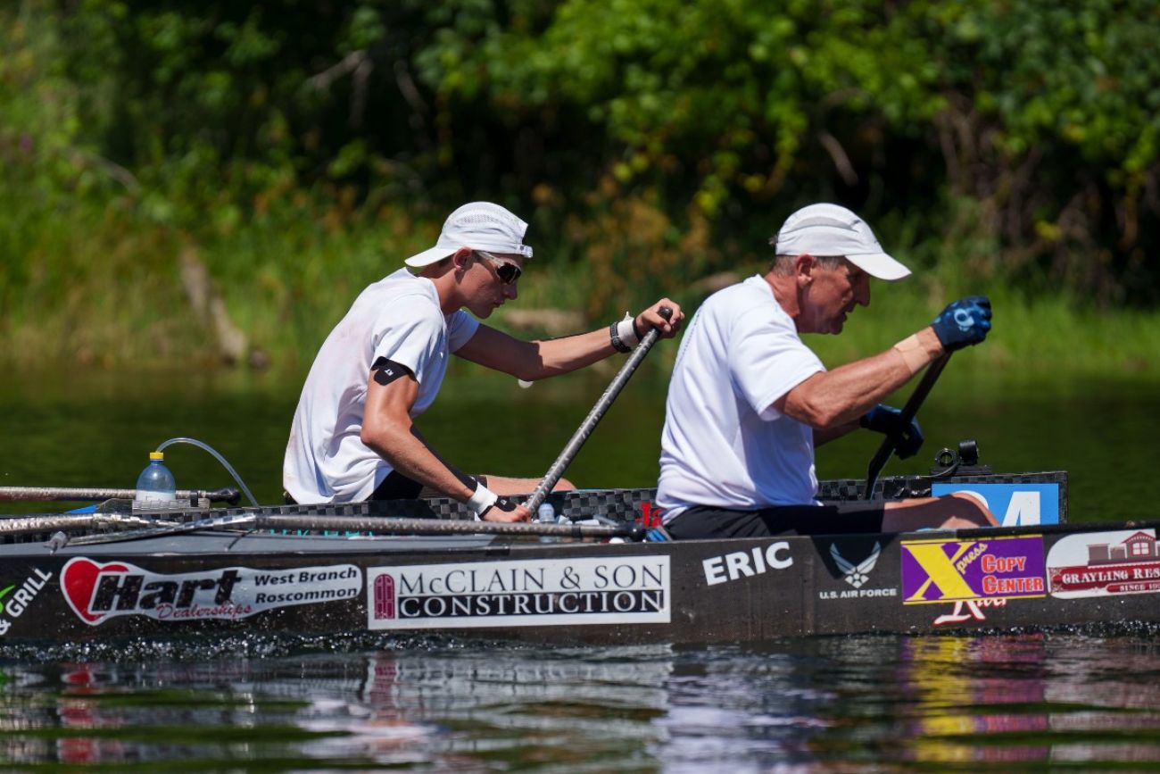 Two men paddle canoes during a race down a river