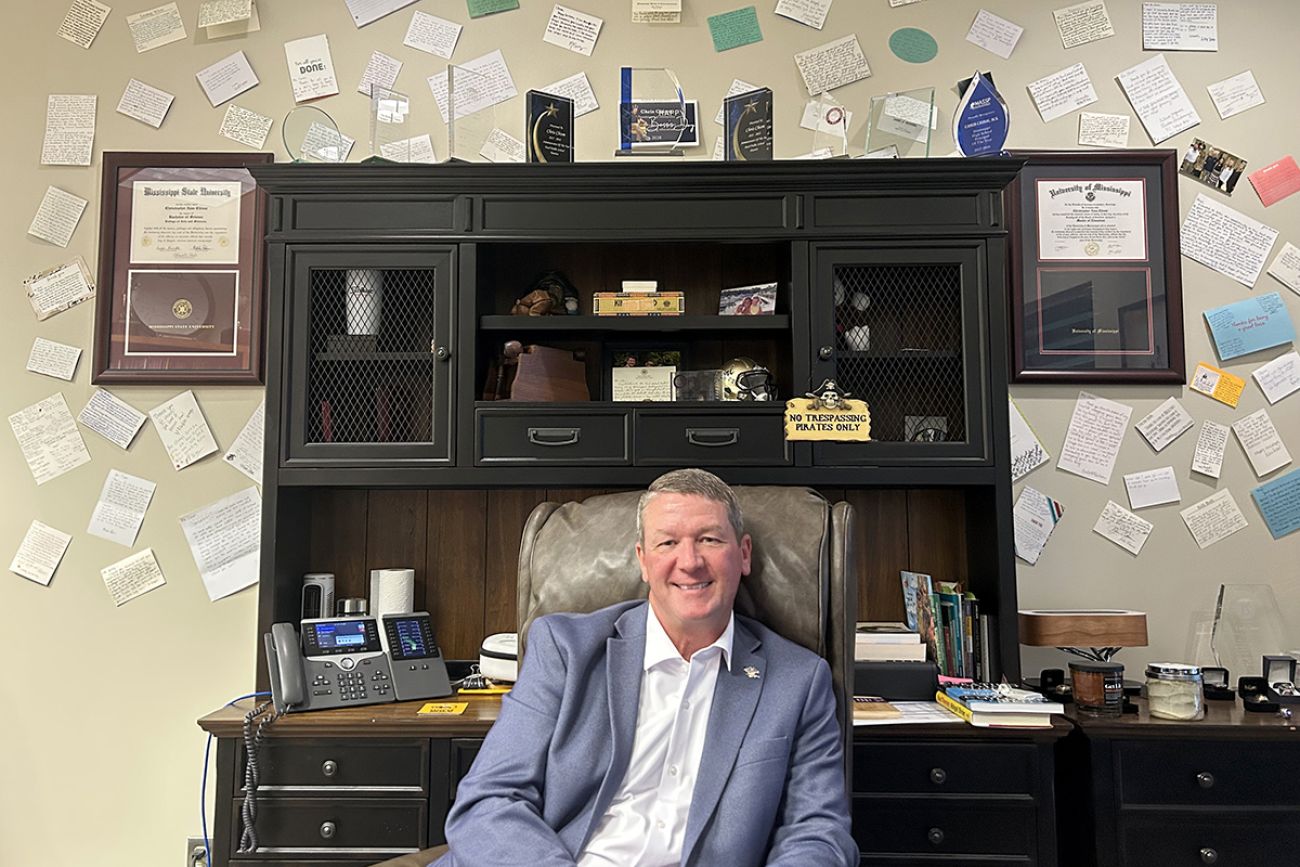 Pearl Public School District Superintendent Chris Chism with a desk behind him.