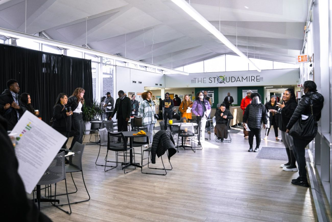 People gather in a large open room that is meant to serve as a refuge during climate disasters