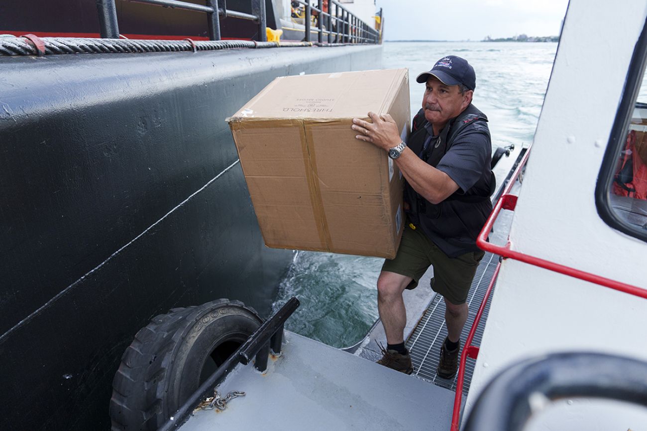 Sam Buchanan carries a cardboard box.