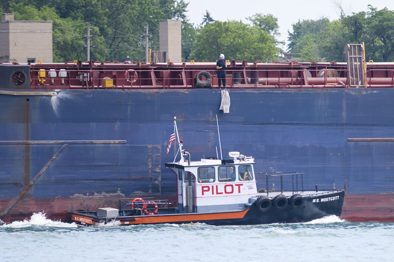 M.S. Westcott right next to a big, blue freighter.