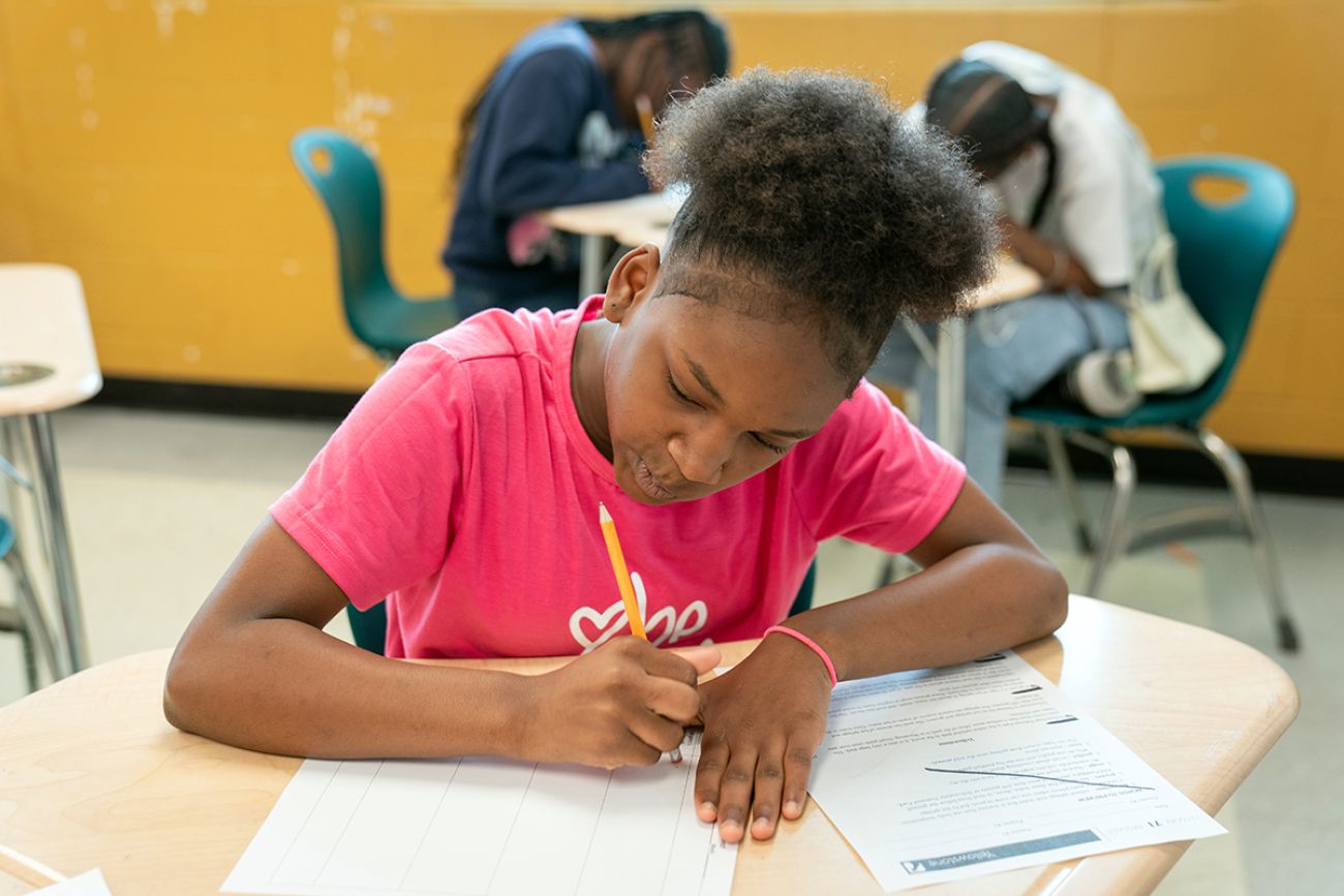 Student Lyric Frazier does work at a desk.